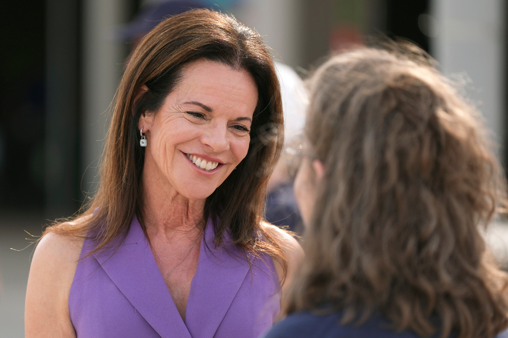 Marlene Galán-Woods, a Democratic candidate for the 1st Congressional District in Arizona, smiles as she speaks with a campaign volunteer at a voting location as voters cast their ballots on primary election day, Tuesday, July 21, 2026, in Phoenix. (AP Photo/Ross D. Franklin)