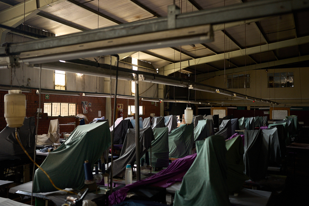 FILE - Sewing machines are lined up inside the empty Tzicc clothing factory following the threat of U.S. imposed tariffs in Maseru, Lesotho, July 22, 2025. (AP Photo/Bram Janssen, File)