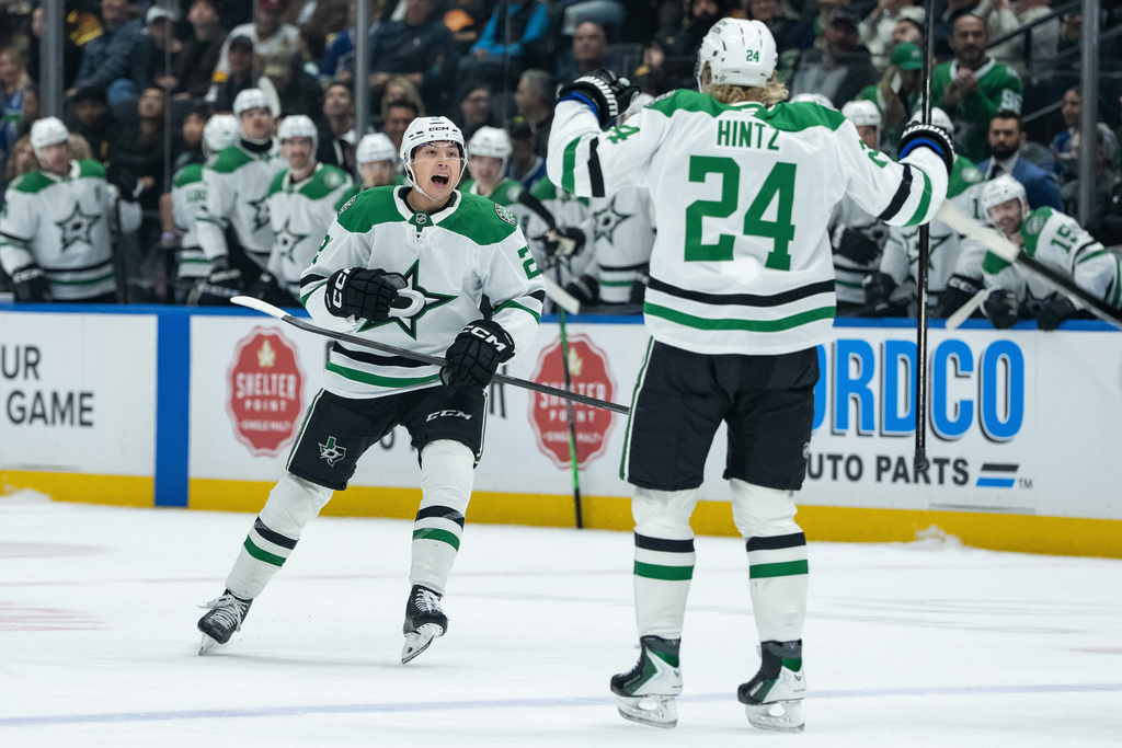Dallas Stars' Jason Robertson, left, celebrates after his goal against the Vancouver Canucks with Roope Hintz (24) during the first period of an NHL hockey game in Vancouver, Thursday, Nov. 20, 2025. (Ethan Cairns/The Canadian Press via AP)