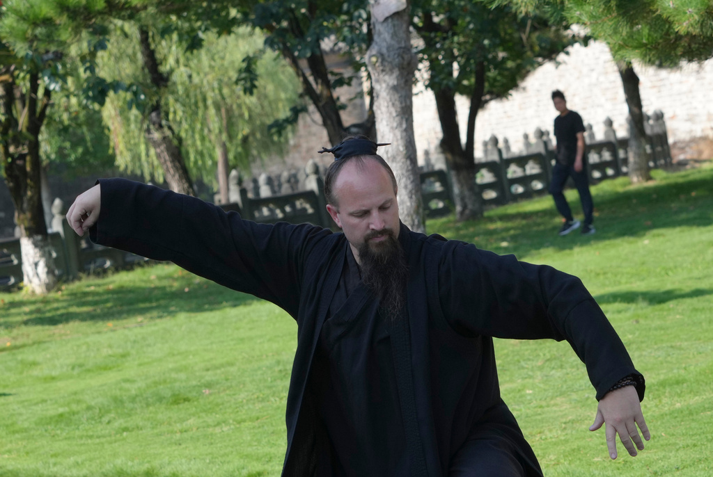 The 16th-generation successor of the Wudang Sanfeng lineage, Jake Pinnick, from the United States, performs Wudang Tai Chi at Yuxu palace near Wudang Mountain in Shiyan city in central China's Hubei province on Friday, Sept. 4, 2026. (AP Photo/Achmad Ibrahim)