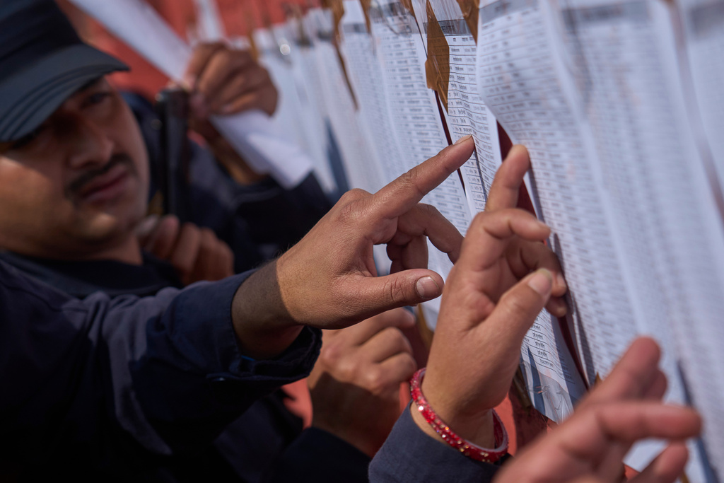 Nepalese police officers check a list showing their postings as they prepare to depart for duty in various regions ahead of the upcoming election in Kathmandu, Nepal, Feb. 23, 2026. (AP Photo/Niranjan Shrestha, file)