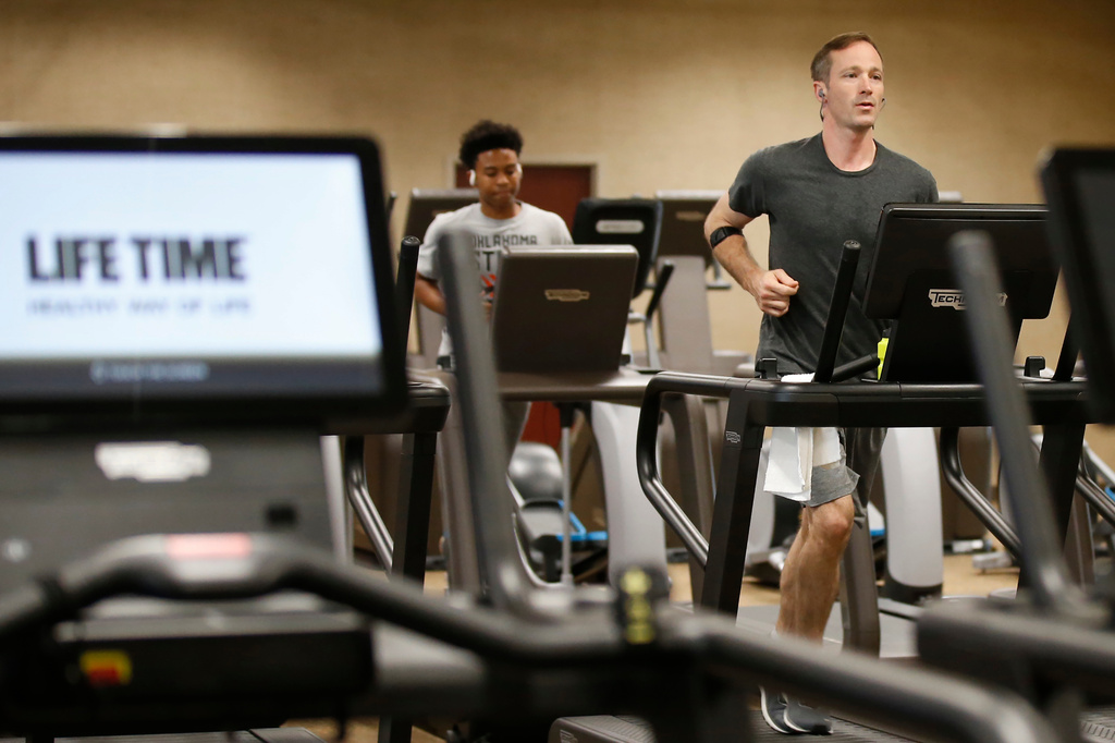 FILE - People run on treadmills at Life Time Athletic May 8, 2020, in Oklahoma City. (AP Photo/Sue Ogrocki, File)