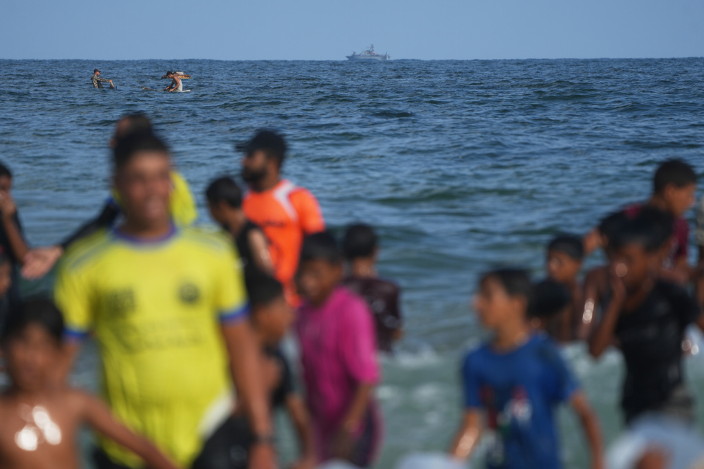 An Israeli navy vessel patrols off the Mediterranean coast as Palestinian children participate in the "Swimming with Gaza" event in Khan Younis, southern Gaza Strip, Friday, Aug. 21, 2026. (AP Photo/Abdel Kareem Hana)