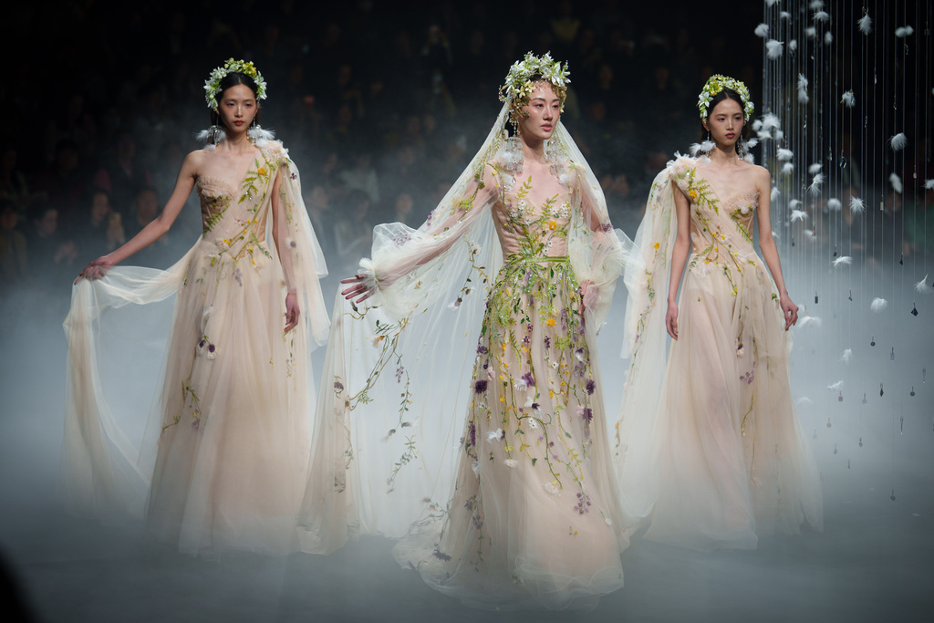 Models wears a creation by Xiong Ying - Heaven Gala during China Fashion Week (Spring) 2026 in Beijing, China, Friday, March 20, 2026. (AP Photo/Vincent Thian)