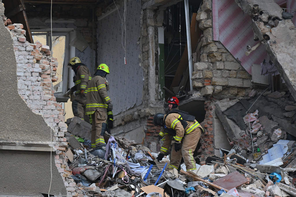 Rescue workers clear the rubble of a residential building which was heavily damaged after a Russian strike in Odesa, Ukraine, Tuesday, Jan. 27, 2026. (AP Photo/Michael Shtekel)