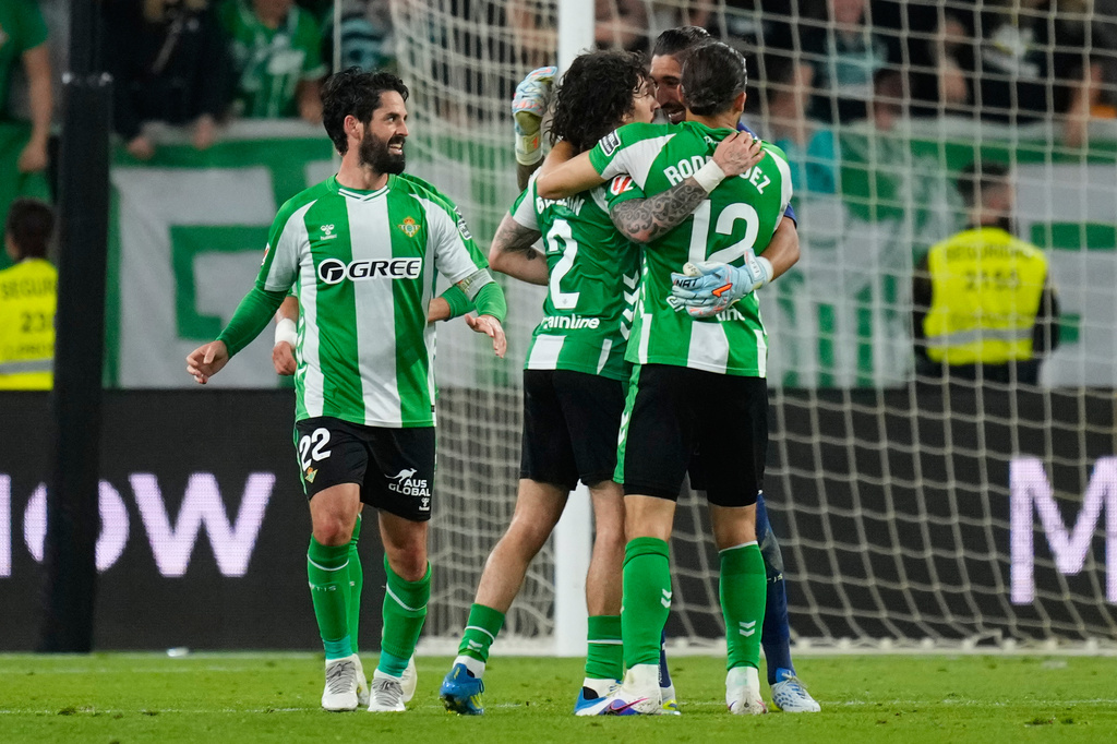 Real Betis players celebrate after scoring during a La Liga soccer match between Real Betis and Real Madrid in Seville, Spain, Friday, April 24, 2026. (AP Photo/Jose Breton)