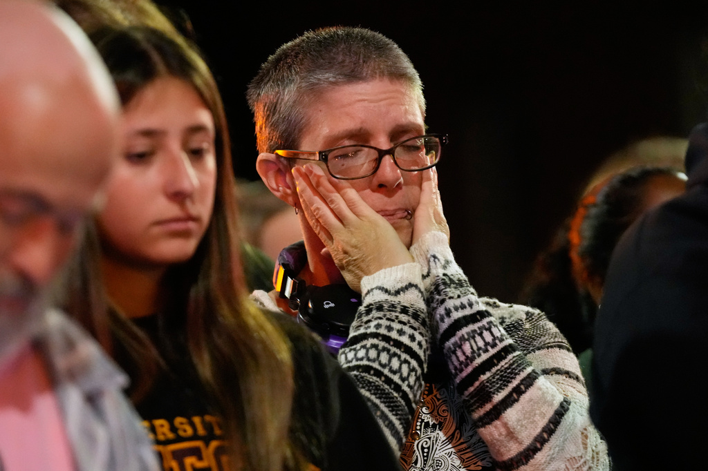 An attendee reacts at a candlelight vigil where a Madison police officer shot and killed a man Wednesday, July 22, 2026, in Madison, Wis. (AP Photo/Kayla Wolf)
