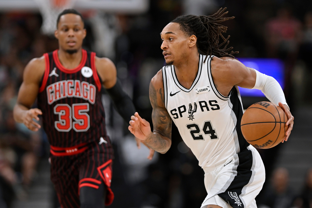 San Antonio Spurs guard Devin Vassell (24) runs up court during the first half of an NBA basketball game against the Chicago Bulls, Monday, March 30, 2026, in San Antonio. (AP Photo/Darren Abate)