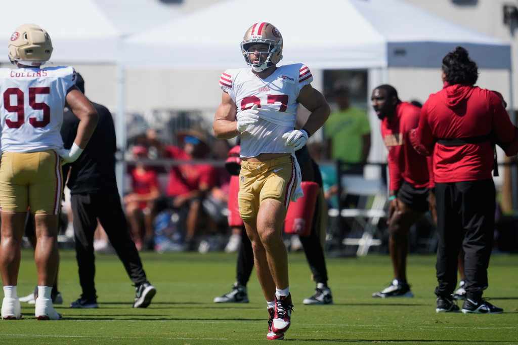 San Francisco 49ers defensive end Nick Bosa jogs on the field during the NFL football team's training camp, Monday, Aug. 3, 2026, in Santa Clara, Calif. (AP Photo/Jeff Chiu)