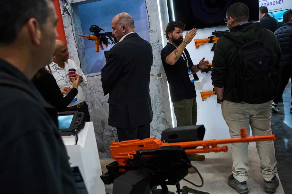 Visitors attend a defense industry exhibition in Tel Aviv, Israel, Tuesday, Feb. 17, 2026. (AP Photo/Oded Balilty)