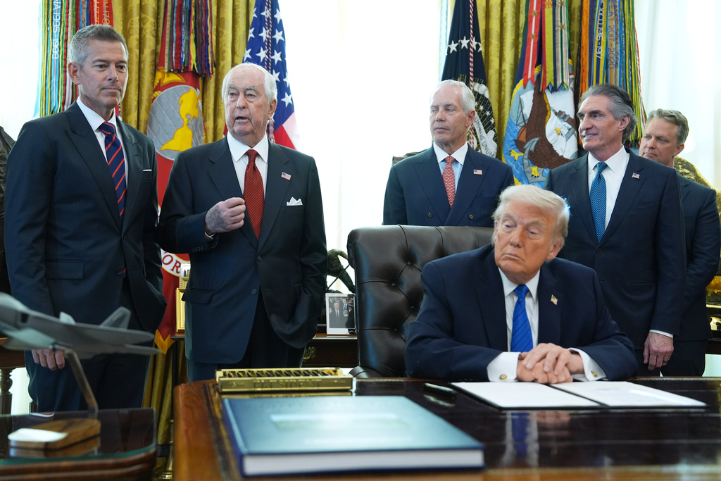 Roger Penske, second left, speaks before President Donald Trump signs executive orders in the Oval Office of the White House, Friday, Jan. 30, 2026, in Washington. (AP Photo/Evan Vucci)