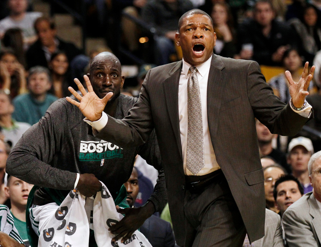 FILE - Boston Celtics coach Doc Rivers shouts at a referee as Kevin Garnett looks on during the first quarter of a NBA basketball game against the New Jersey Nets in Boston, Nov. 24, 2010. (AP Photo/Winslow Townson, File)