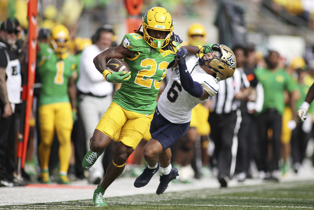 Oregon running back Dierre Hill Jr. (23) stiff-arms Montana State defensive back Bryant Meredith (6) during the second half of an NCAA college football game, Saturday, Aug. 30, 2025, in Eugene, Ore. (AP Photo/Lydia Ely)