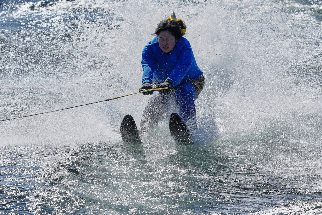 A student dressed as an 'Oni', demon-like figures in Japanese folklore, water skis during the annual Bean Throwing Festival near Hakone Shrine in Hakone, Japan, Tuesday, Feb. 3, 2026. (AP Photo/Eugene Hoshiko)