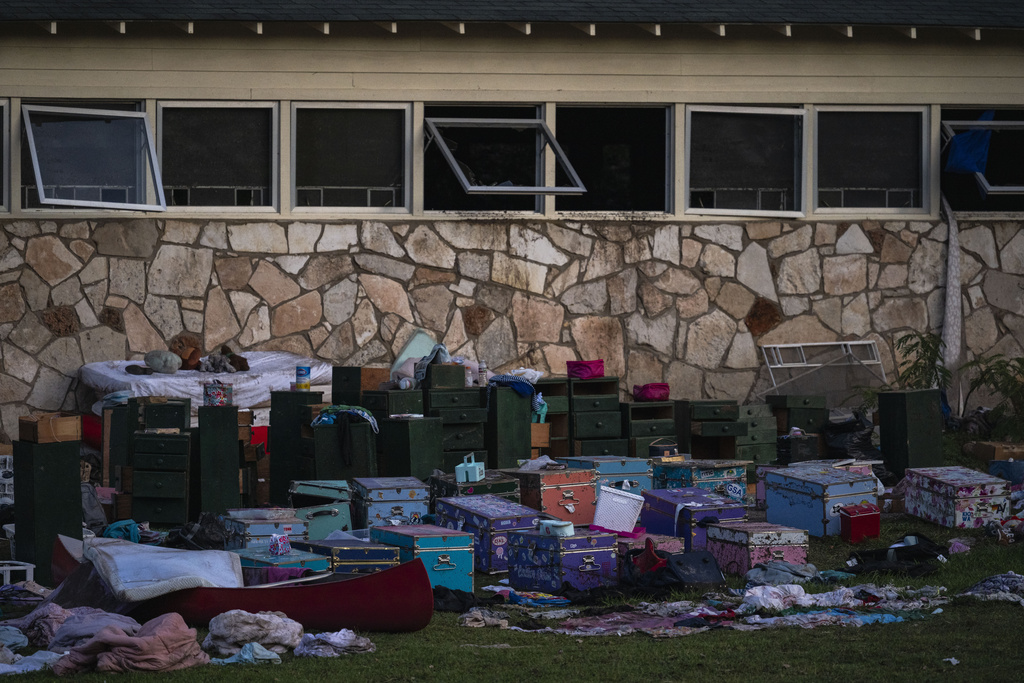 Campers belongings sit outside one of Camp Mystic's cabins near the Guadalupe River after a flash flood swept through the area Monday, July 7, 2025, in Hunt, Texas. (AP Photo/Eli Hartman)