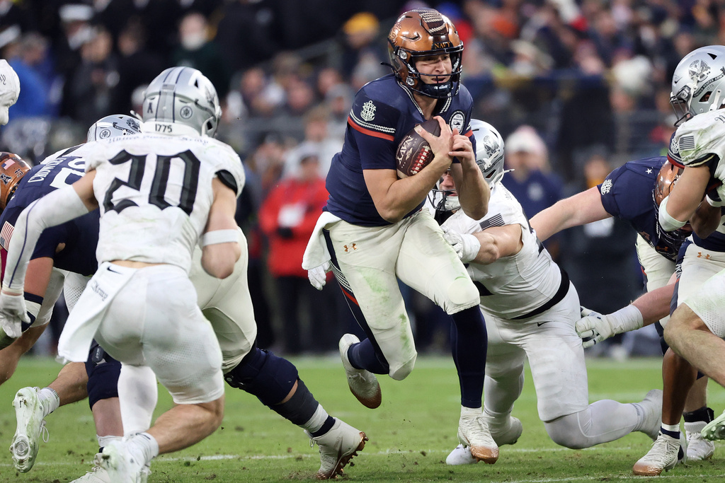 Navy quarterback Blake Horvath runs with the ball during the first half of an NCAA college football game against Army, Saturday, Dec. 13, 2025, in Baltimore. (AP Photo/Daniel Kucin Jr.)