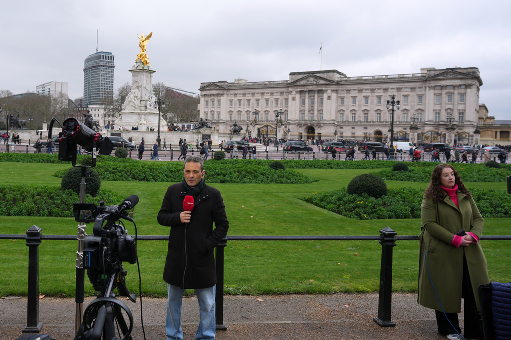 Reporters stand in front of Buckingham Palace in London, Thursday, Feb. 19, 2026 after Andrew Mountbatten-Windsor was arrested by British police on suspicion of misconduct in public office. (AP Photo/Kin Cheung)