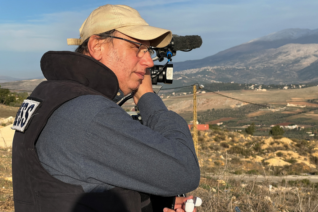 Hezbollah's al-Manar TV correspondent Ali Shoeib, who was killed in an Israeli strike in Jezzine with other journalists on Saturday, March 28, 2026, speaks on his mobile phone in Marjayoun town, Wednesday, Nov. 22, 2024. (AP Photo/Hussein Malla)