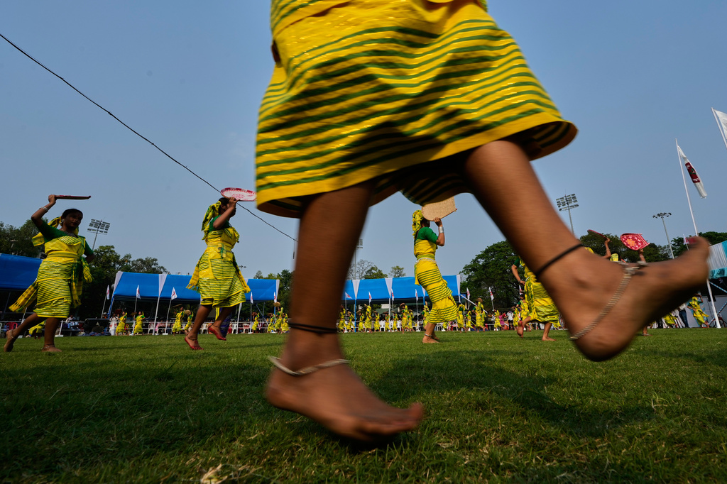 Koch Rajbonshi girls in traditional attire perform their Guwaloni dance during the Rongali Bihu festival, organized by the All Assam Students Union in Guwahati, in the northeastern state of Assam, India, Tuesday, April 14, 2026. (AP Photo/Anupam Nath) CORRECTION: Corrects location detail; removes incorrect reference to Guwahati as the capital of Assam.