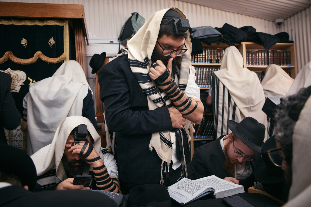 Chabad-Lubavitch rabbis gather in prayer at the resting place of the Rebbe, Rabbi Menachem M. Schneerson, one of Judaism’s most influential figures, in the Queens borough of New York on Friday, Nov. 14, 2025, during the International Conference of Chabad-Lubavitch Emissaries. (AP Photo/Andres Kudacki)