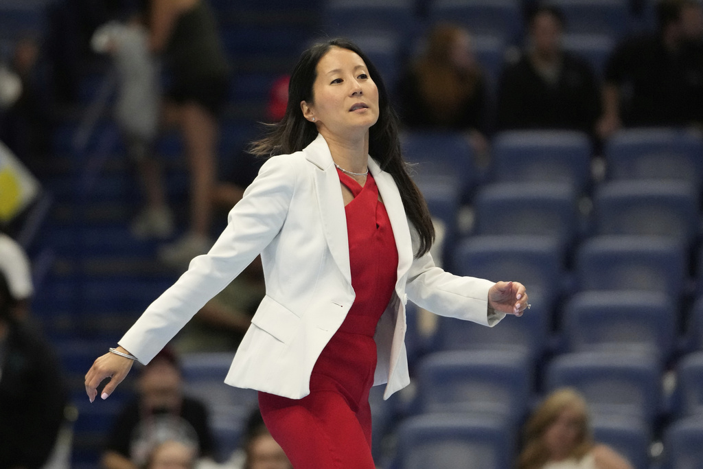 USA Gymnastics president Li Li Leung walks on stage after the senior men's finals of the U.S. Gymnastics Championships in New Orleans, Saturday, Aug. 9, 2025. (AP Photo/Gerald Herbert)