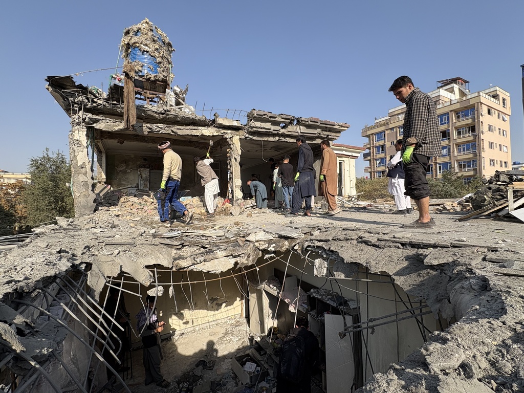Residents remove debris from a house damaged by Wednesday's two drone strikes, in Kabul, Afghanistan, Thursday, Oct. 16, 2025. (AP Photo/Siddiqullah Alizai)