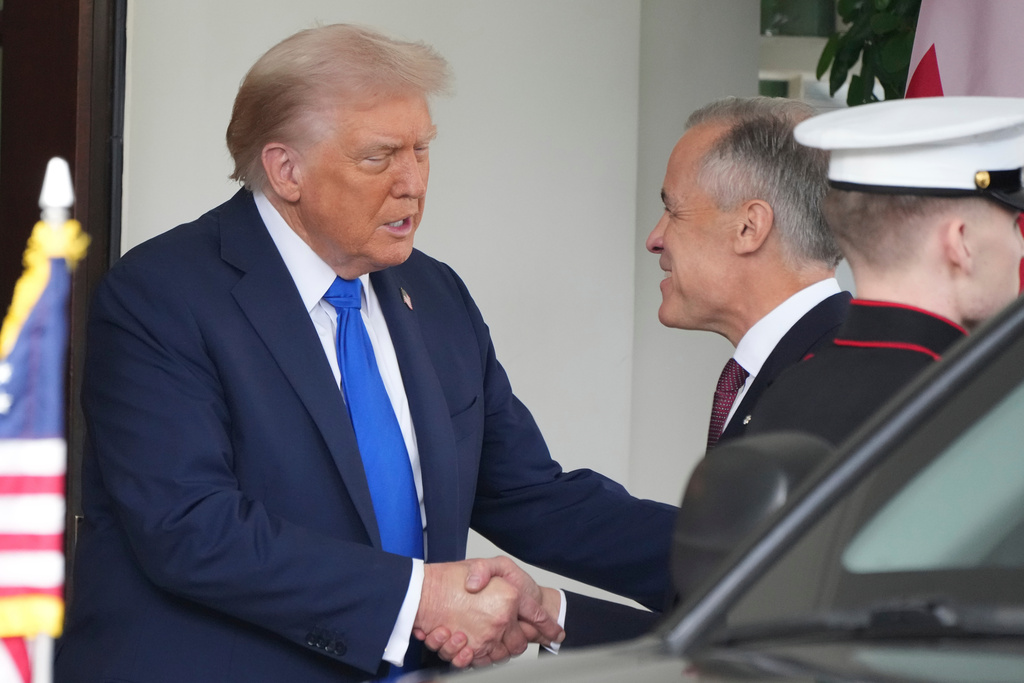 President Donald Trump greets Canada's Prime Minister Mark Carney, as he arrives at the White House, Tuesday, Oct. 7, 2025, in Washington. (AP Photo/Jacquelyn Martin)