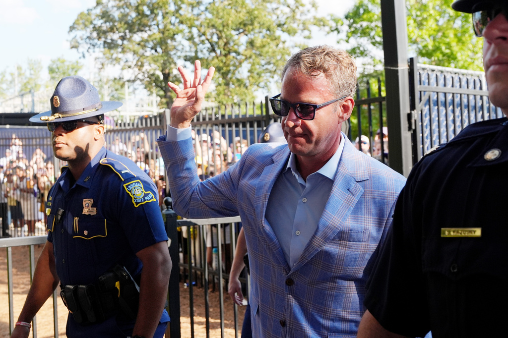 LSU football coach Lane Kiffin waves to fans as he enters the Vaught-Hemingway Stadium prior to an NCAA college football game against Mississippi in Oxford, Miss., Saturday, Sept. 19, 2026. (AP Photo/Rogelio V. Solis)