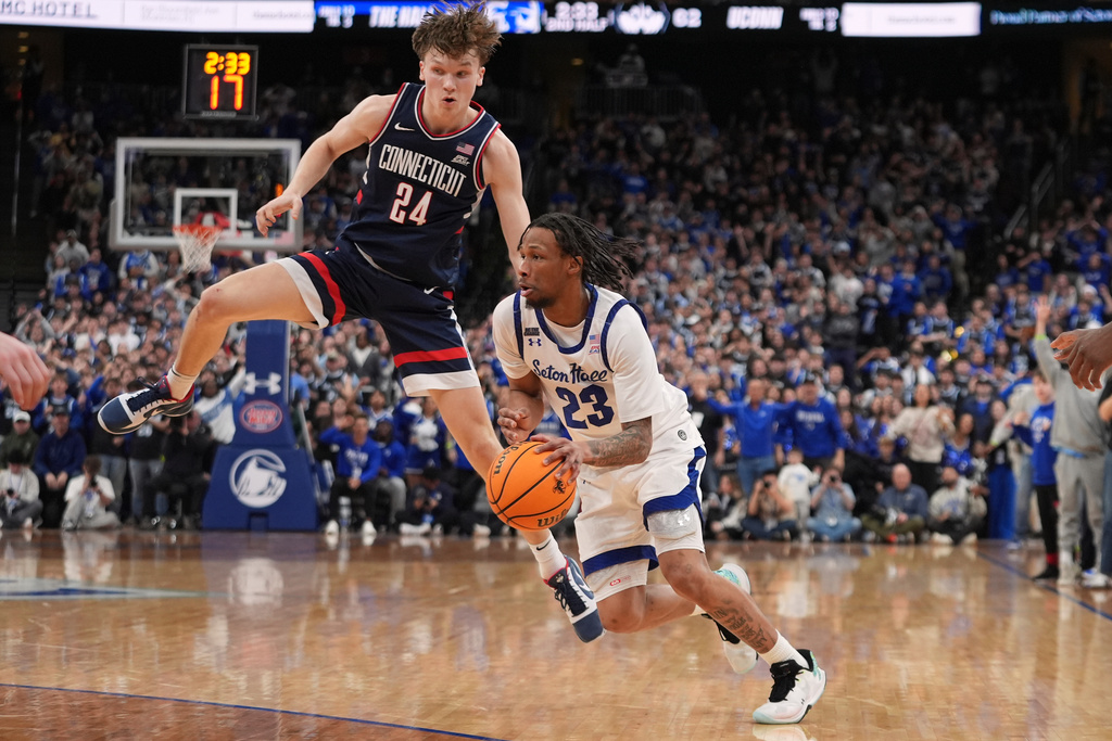Seton Hall's Mike Williams III (23) drives past UConn's Braylon Mullins (24) during the second half of an NCAA basketball game Tuesday, Jan. 13, 2026, in Newark, N.J. (AP Photo/Frank Franklin II)