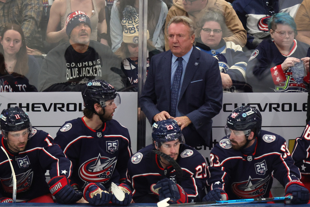 Columbus Blue Jackets coach Rick Bowness, center top, looks on during the third period of an NHL hockey game against the Winnipeg Jets in Columbus, Ohio, Saturday, April 4, 2026. (AP Photo/Paul Vernon)