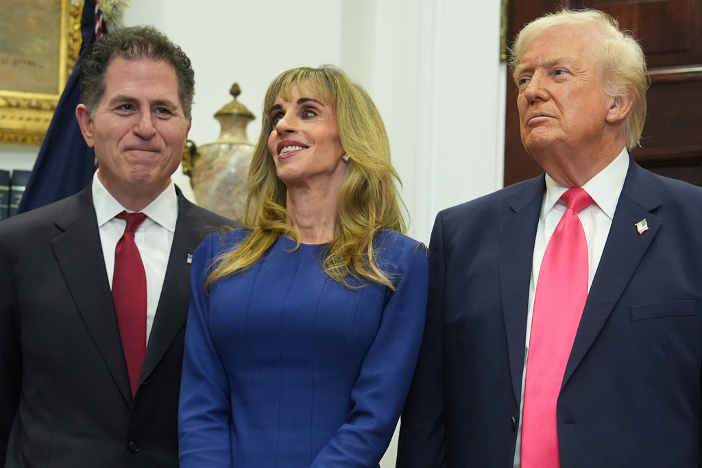 Michael Dell, left, his wife Susan and President Donald Trump listen during an event on "Trump Accounts" for kids in the Roosevelt Room of the White House, Tuesday, Dec. 2, 2025, in Washington. (AP Photo/Evan Vucci)