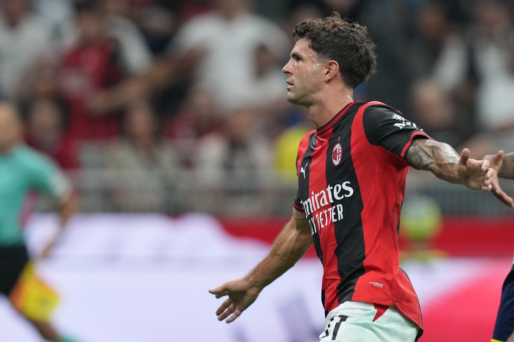 AC Milan's Christian Pulisic celebrates after scoring his side's opening goal during the Serie A soccer match between AC Milan and Lecce, in Milan, Italy, Sunday, Sept. 20, 2026. (AP Photo/Antonio Calanni)