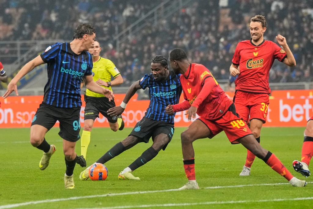 Inter Milan's Marcus Thuram, 2nd left, scores his side's third goal during the Italian soccer cup round of sixteen match between Inter Milan and Venezia, at the San Siro stadium in Milan, Italy, Wednesday, Dec.3, 2025. (AP Photo/Luca Bruno)