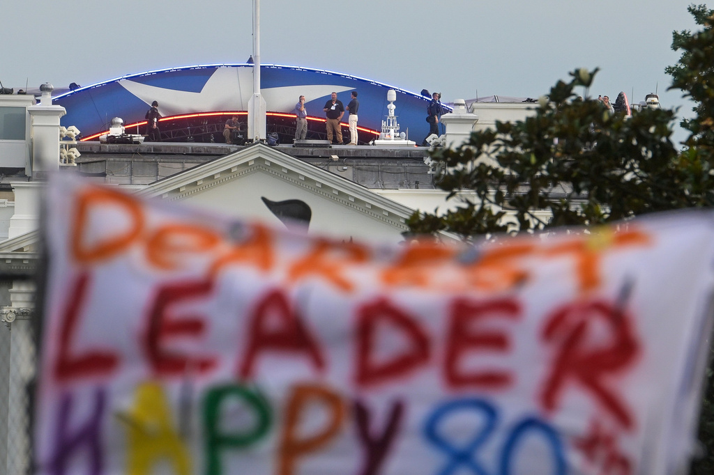 People are seen on the roof of the White House prior to the UFC Freedom 250 fights taking place on the South Lawn in Washington, Sunday, June 14, 2026. (AP Photo/Rod Lamkey, Jr.)