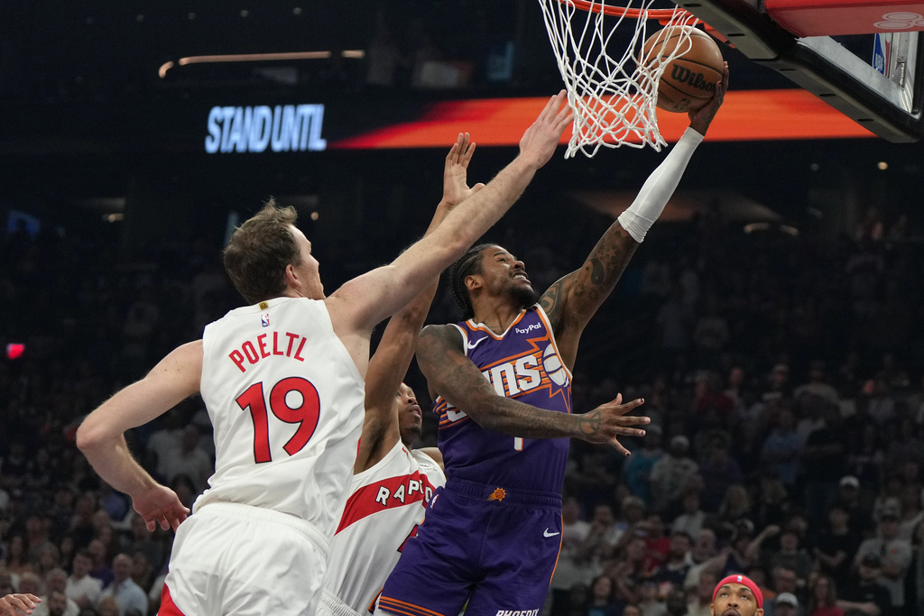 Phoenix Suns guard Jalen Green (4) drives past Toronto Raptors center Jakob Poeltl during the first half of an NBA basketball game, Sunday, March 23, 2026, in Phoenix. (AP Photo/Rick Scuteri)