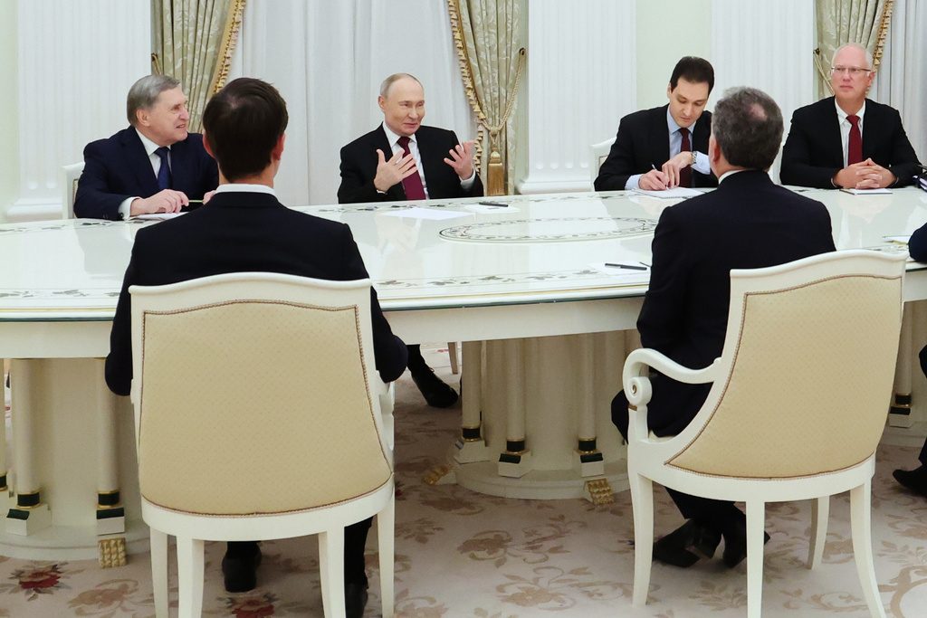 FILE - Russian President Vladimir Putin, center-left, Russian presidential foreign policy adviser Yuri Ushakov, left, and Russian Direct Investment Fund CEO Kirill Dmitriev, right, attend talks with U.S. special envoy Steve Witkoff, right back to a camera, and Jared Kushner, U.S. President Donald Trump’s son-in-law, left back to a camera, in Moscow, on Dec. 2, 2025. (Alexander Kazakov, Sputnik, Kremlin Pool Photo via AP, File)