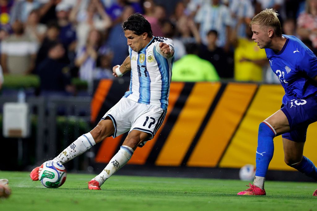 Argentina forward Giuliano Simeone (17) kicks an attempt on goal as Iceland Daniel Gudjohnsen (21) defends during the first half of an international friendly match, Tuesday, June 9, 2026, in Auburn, Ala. (AP Photo/Butch Dill)