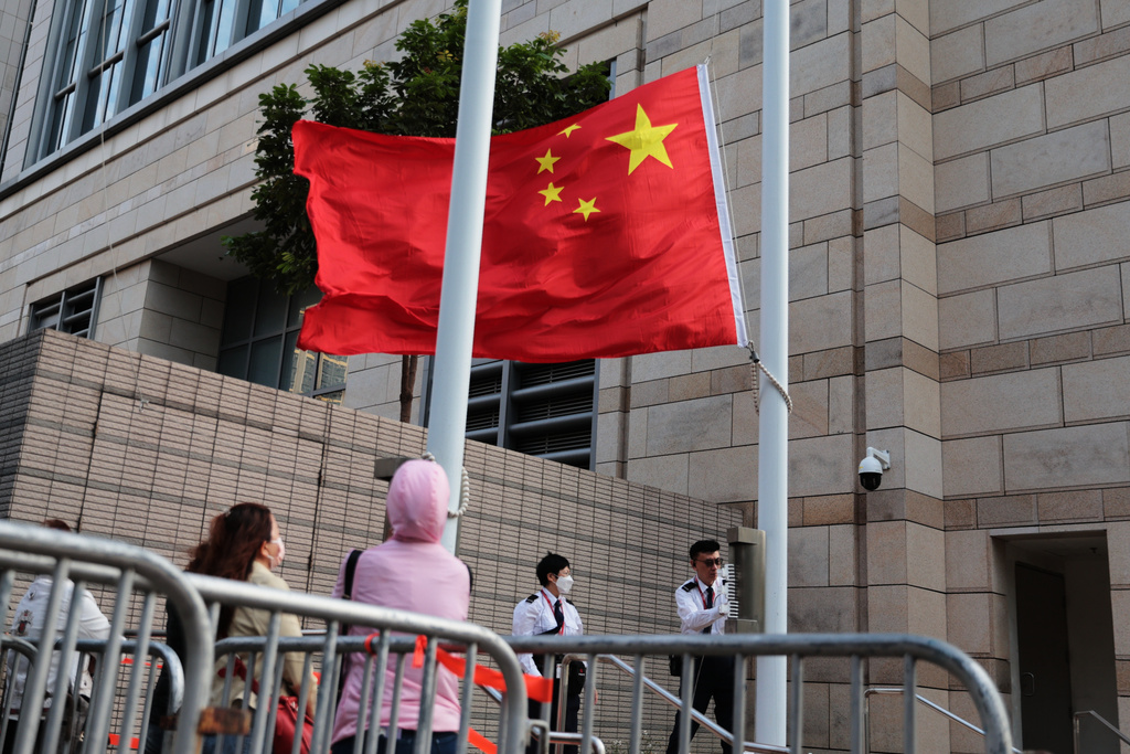 Staff members of the West Kowloon Magistrates' Courts raise a China national flag outside West Kowloon Law Courts Building ahead of the national security appeal cases, in Hong Kong, Monday, Feb. 23, 2026. (AP Photo/May James)