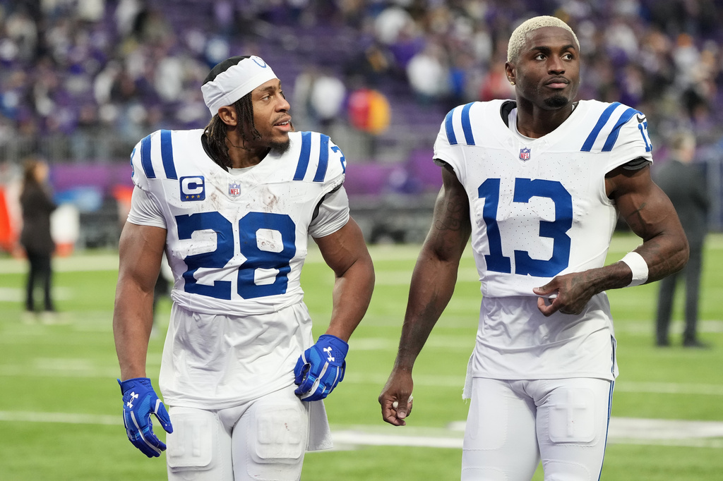 Indianapolis Colts running back Jonathan Taylor (28) and wide receiver Laquon Treadwell (13) react as they walk off the field after an NFL football game against the Minnesota Vikings in Minneapolis, Sunday, Oct. 25, 2026. (AP Photo/Ellen Schmidt)