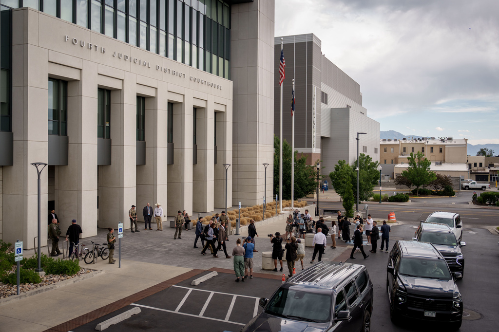 Journalists gather around as Charlie Kirk's parents exit with security guards after a preliminary hearing for Tyler Robinson, who is accused in the fatal shooting of Charlie Kirk, at the Fourth District Courthouse in Provo, Utah, Thursday, July 9, 2026. (AP Photo/Spenser Heaps)
