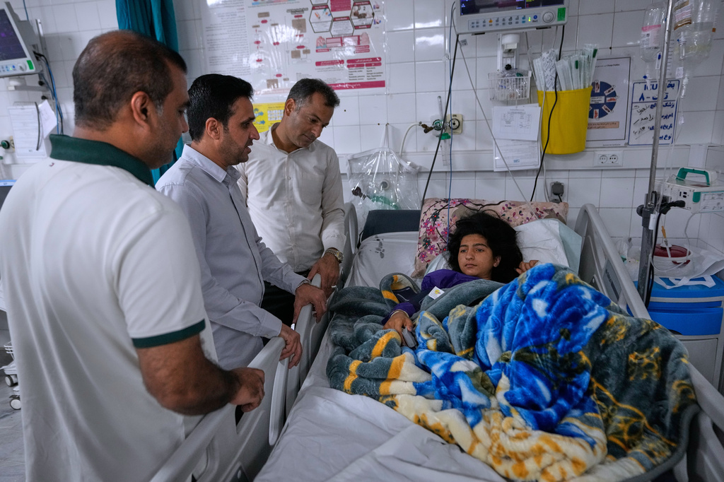 Relatives visit Kiana Karimi, 14, who was wounded during a strike what Iranian media said was a U.S. strike late Tuesday, in Kuhestak, as she lies on the bed in a hospital in town of Minab in southern Iran, Saturday, Sept. 5, 2026. (AP Photo/Vahid Salemi)