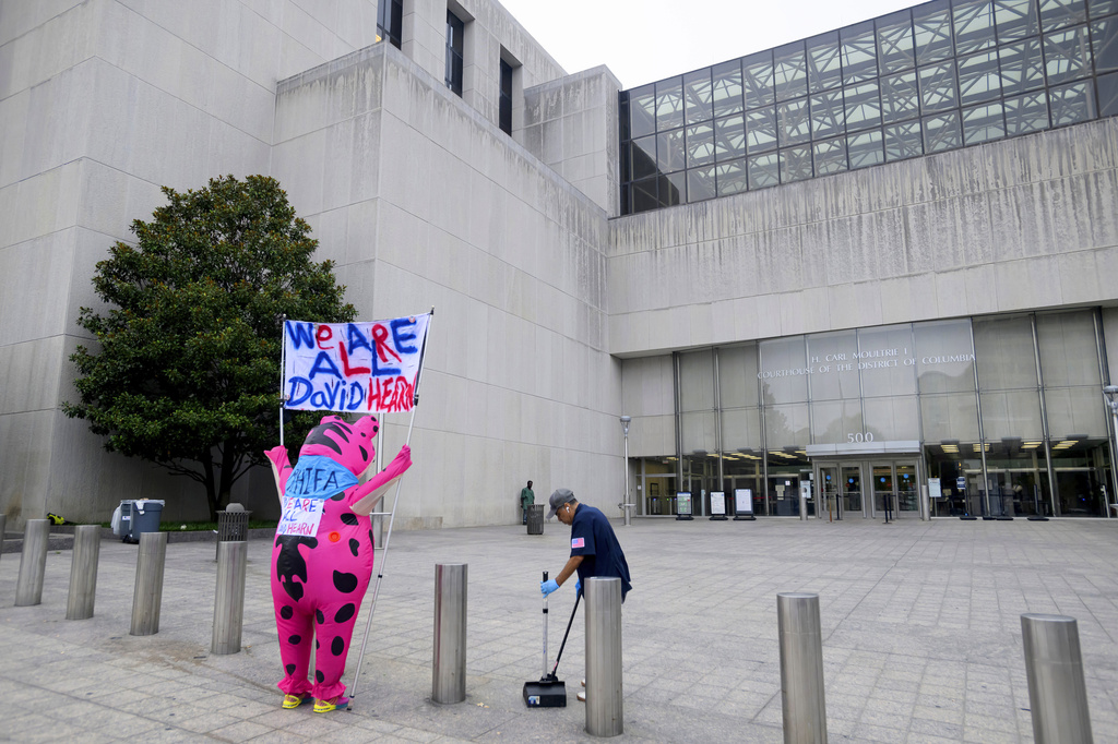 Nadine Seiler arrives in an inflatable frog costume, to support former Olympic canoeist David Hearn, who was indicted by a grand jury for allegedly damaging the Lincoln Memorial Reflecting Pool, before he arrives at D.C. Superior Court, Thursday, July 9, 2026, in Washington. (AP Photo/Rod Lamkey, Jr.)