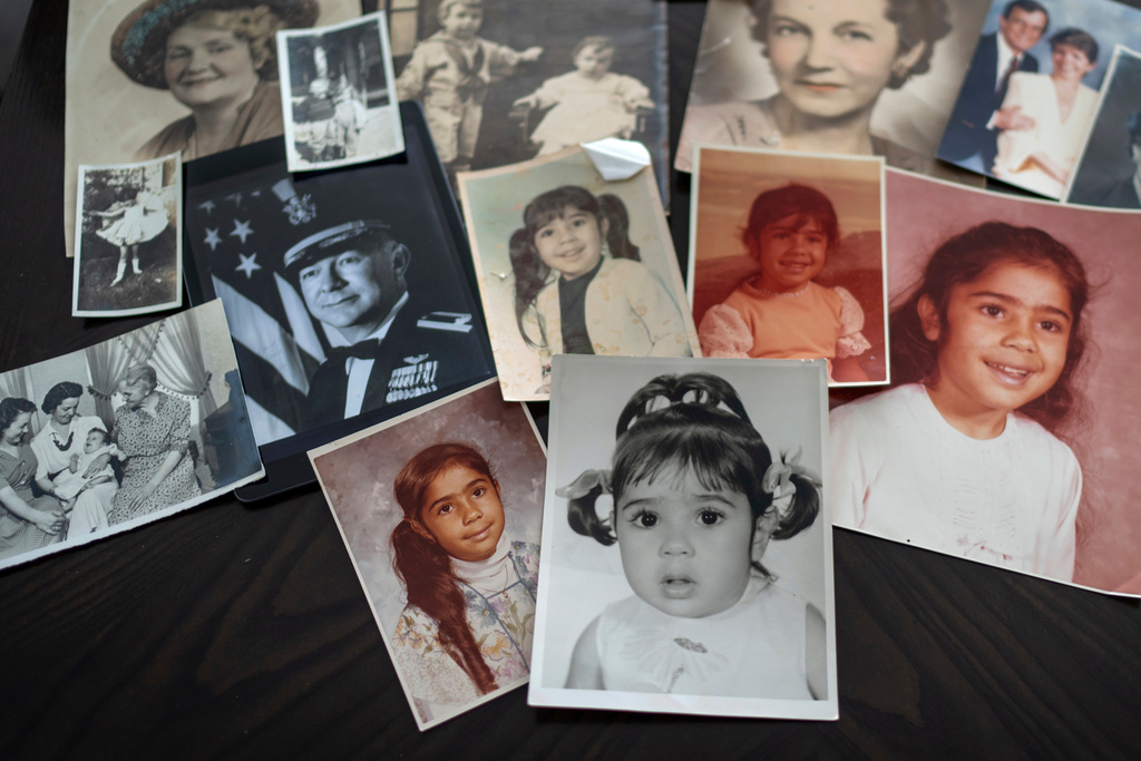 FILE - Childhood photos of a woman adopted as a toddler by an American war veteran, who he found in the 1970s in an Iranian orphanage and raised as a Christian, are displayed along with a picture of her father, a WWII Air Force veteran, at left, and additional family photos, Monday, June 24, 2024, in Henderson, Nev. (AP Photo/David Goldman, File)