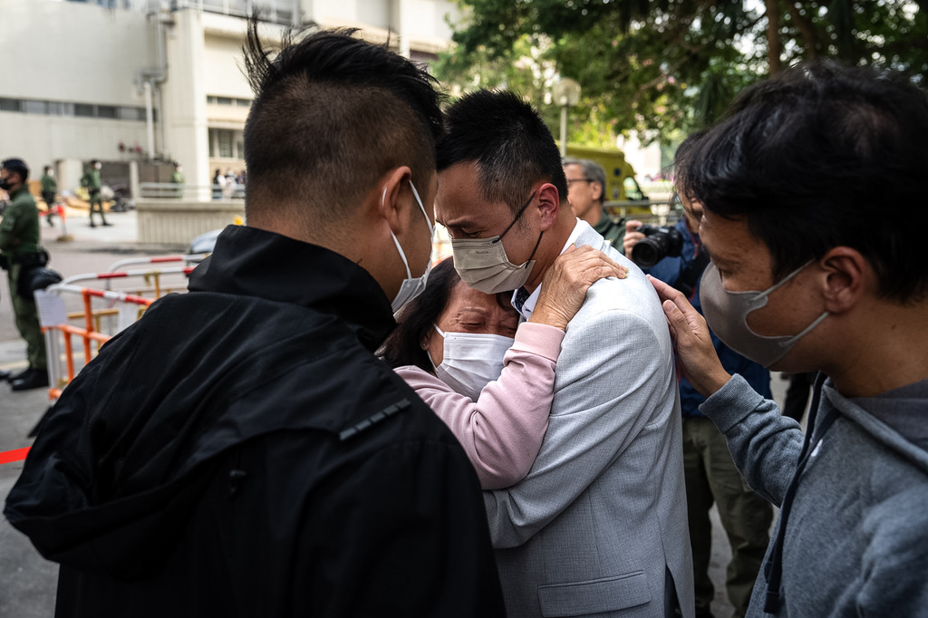 People with missing family members react after checking photographs of the deceased at the fire scene at Wang Fuk Court, a residential estate in the Tai Po district of Hong Kong's New Territories, Thursday, Nov. 27 2025. (AP Photo/Chan Long Hei)