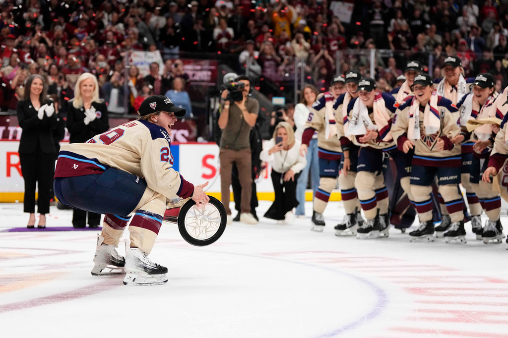 Montreal Victoire's Marie-Philip Poulin (29) carries the PWHL Walter Cup to her teammates, after the team's win against the Ottawa Charge, in Ottawa, on Wednesday, May 20, 2026. (Justin Tang/The Canadian Press via AP) CORRECTION: name of photographer Justin Tang