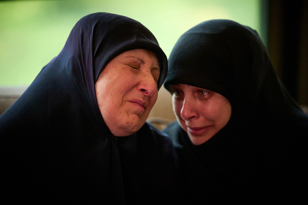 Ahlam Badawi, 51, left, mother of Hassan Ali Badawi, 31, a paramedic of the Lebanese Red Cross killed in a Israeli strike, cries during his funeral in Choueifat, Lebanon, Monday, April 13, 2026. (AP Photo/Emilio Morenatti)