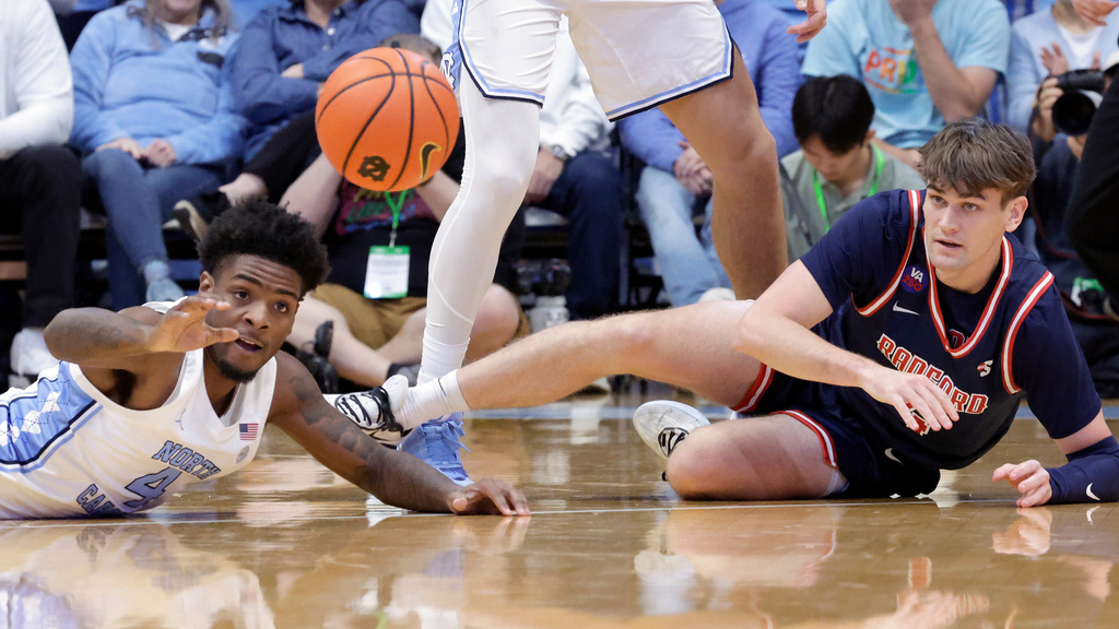 North Carolina guard Jaydon Young (4) and Radford guard Brennan Rigsby, right, go for a loose ball during the first half of an NCAA college basketball game, Tuesday, Nov. 11, 2025, in Chapel Hill, N.C. (AP Photo/Chris Seward)