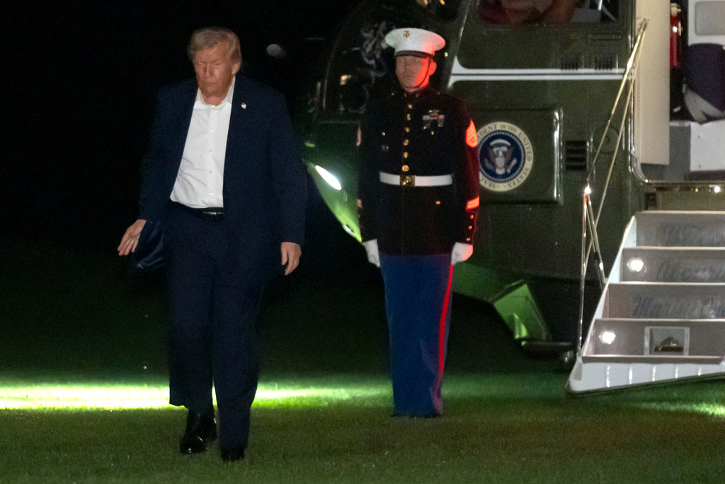 President Donald Trump walks across the South Lawn of the White House, early Tuesday, Oct. 14, 2025, in Washington, after returning from a trip to Israel and Egypt. (AP Photo/Mark Schiefelbein)