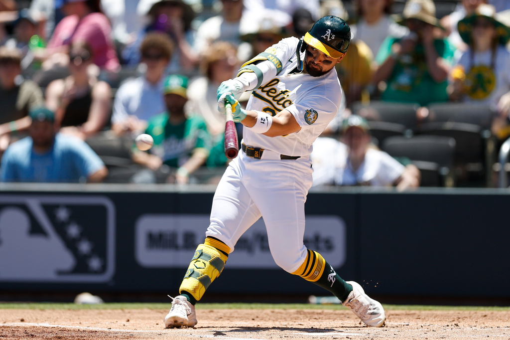 Athletics' Carlos Cortes hits a two run single during the first inning of a baseball game against the Colorado Rockies, Sunday, June 14, 2026, in Las Vegas. (AP Photo/Caroline Brehman)