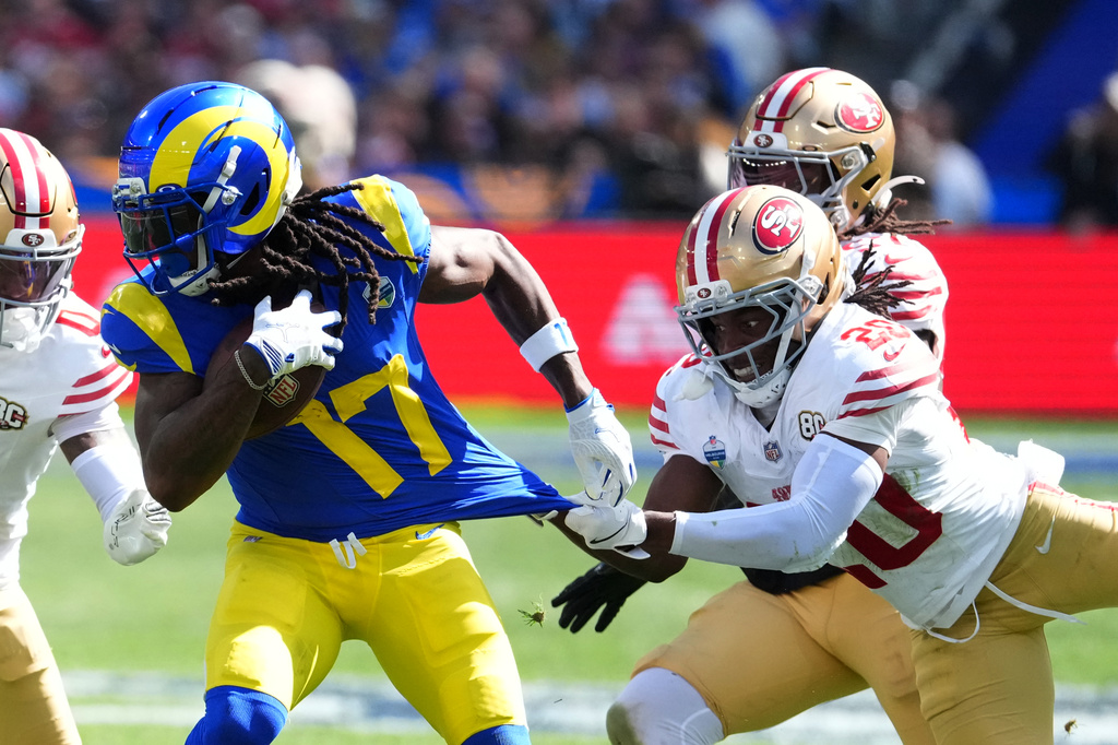 Los Angeles Rams wide receiver Davante Adams is tackled by San Francisco 49ers cornerback Upton Stout during the second half of an NFL football game, Friday, Sept. 11, 2026, in Melbourne, Australia. (AP Photo/Scott Barbour)